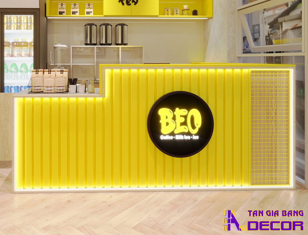 Tổng hợp 50 mẫu thiết kế quầy trà sữa đẹp! 45 Quầy pha chế trà sữa giá rẻ với mặt trước ốp lam nhựa vàng đi led quanh viền.